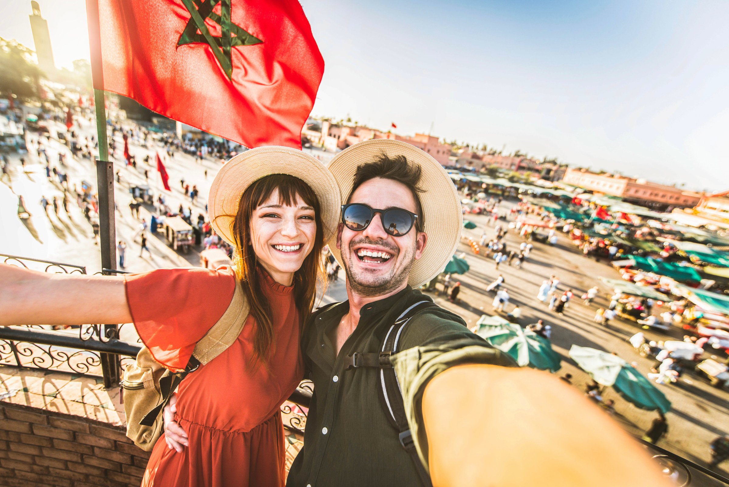 Happy tourists couple visiting Jamaa el-Fna market Marrakech, Mo